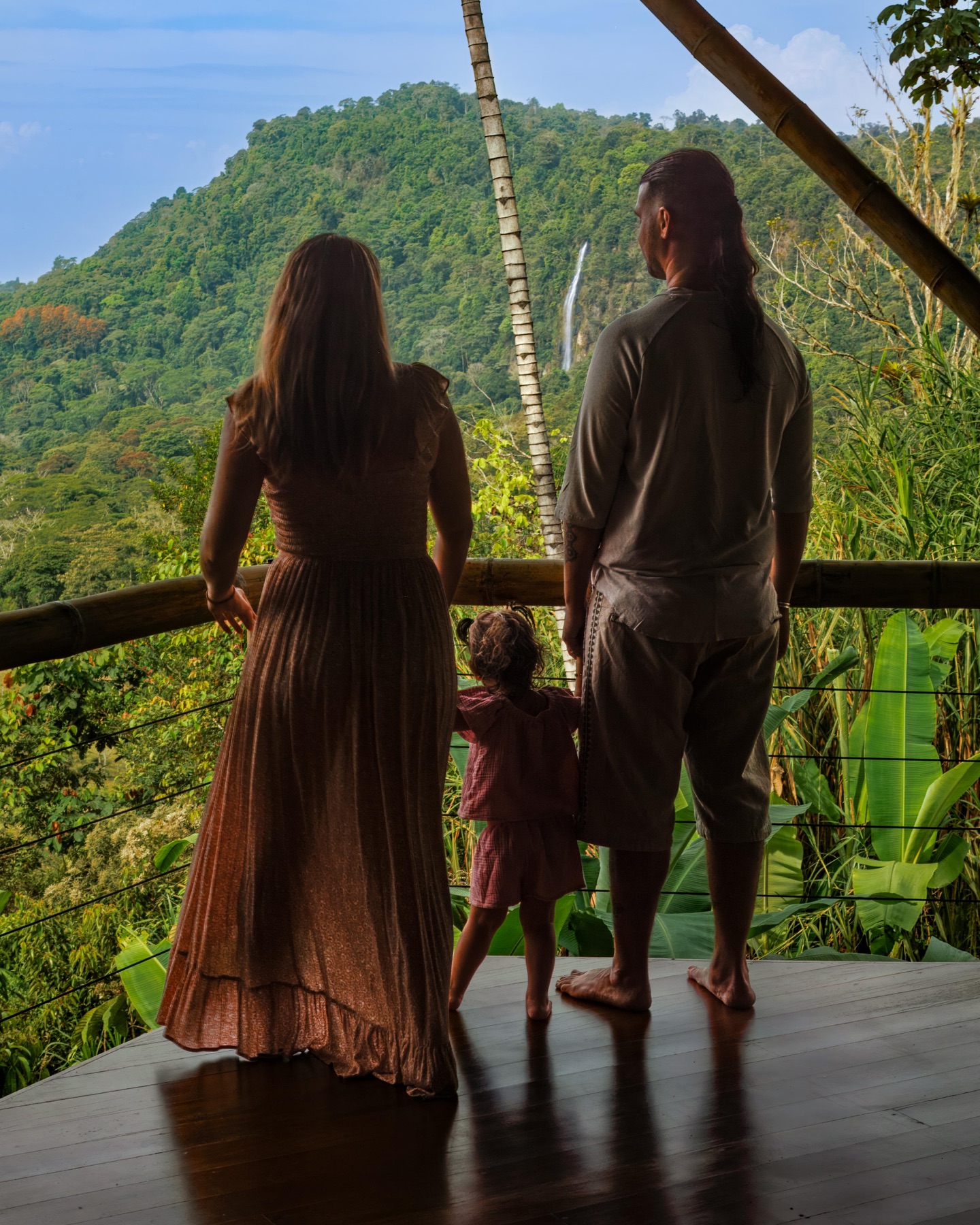 The family behind Metamorfinca looking toward the San Luis waterfall in Costa Rica