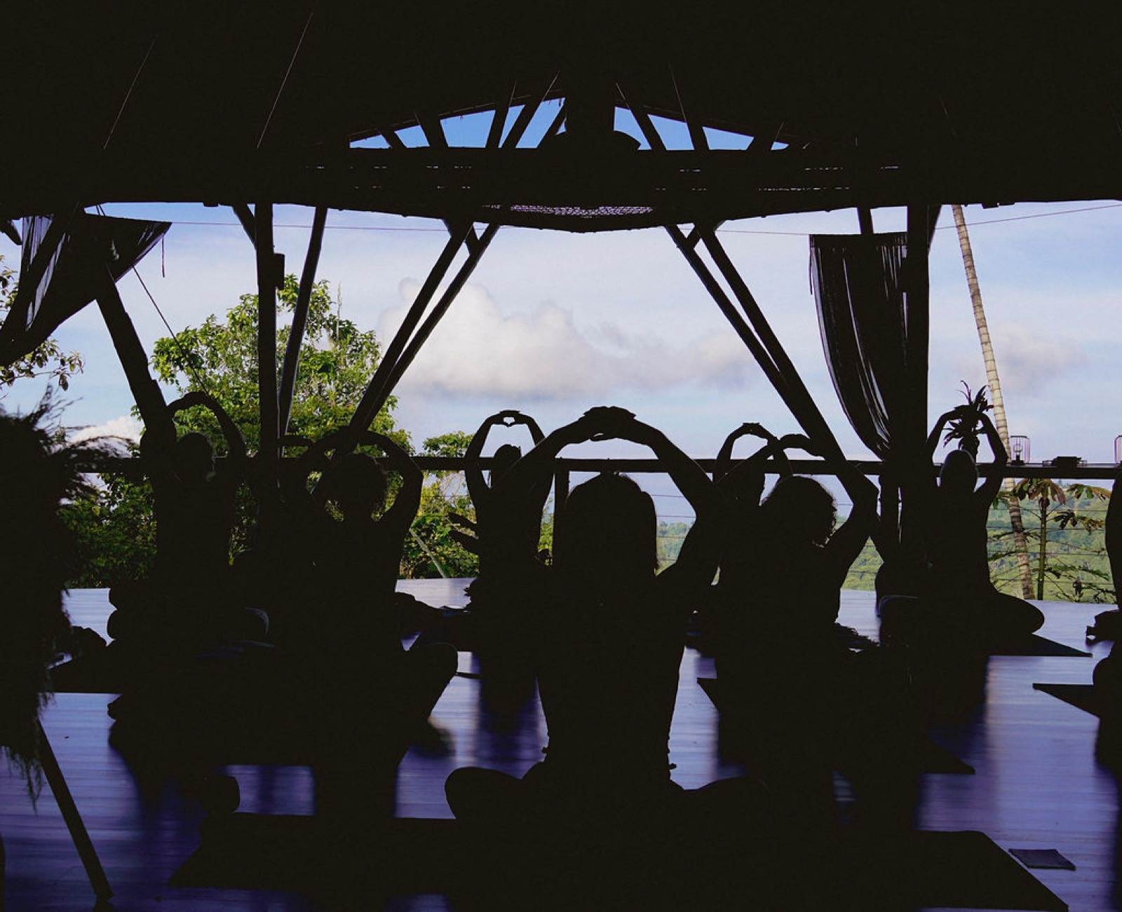 Retreat guests gathering in the bamboo Yoga Shala at Metamorfinca